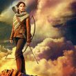 katniss stands on a hill with a bow